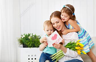 Happy mother`s day! Children congratulates moms and gives her a