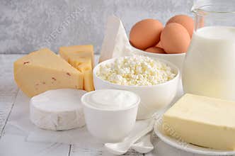 Fresh dairy products. Milk, cheese, brie, Camembert, butter, yogurt, cottage cheese and eggs on wooden table.