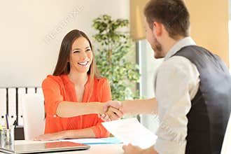 Employee and boss handshaking after a job interview