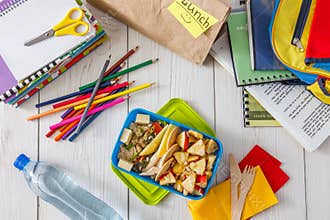 Healthy school lunch box on white wood background, top view