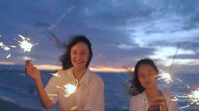 Girls on the beach with sparklers