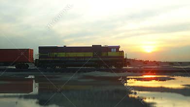 Freight train with cargo containers. Against Sunrise. logistic concept. Realistic cinematic 4k.