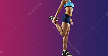 Young fitness woman stretching legs. Isolated