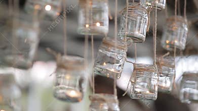 Mason jar candle hanging on tree for wedding decor