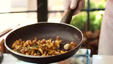Throwing food in a pan.