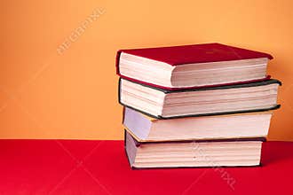 Old books on a wooden shelf. No labels, blank spine.