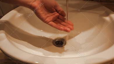 Faucet water runs in sink, starts out dirty rusty golden brown then turns clean