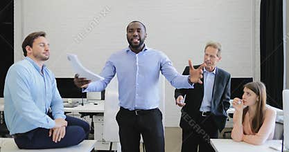 Serious businessman leading presentation during meeting in boardroom, business people group listening to report from