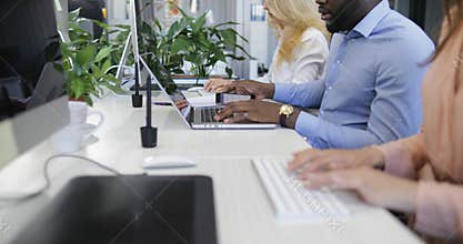 Open business office with busy staff members typing on computers, businesspeople group mix race team working in modern