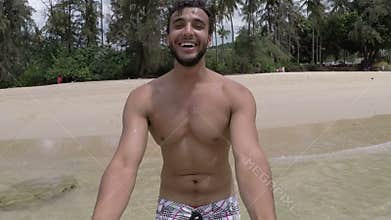 Handsome latin man walk on beach holding hand talking action camera pov of young couple on seaside