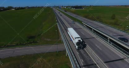 AERIAL: Freight truck transporting cargo container on a highway