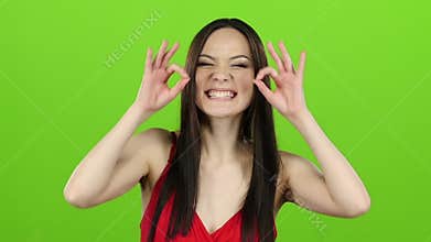 Asian girl posing in camera and she smiling. Green screen. Slow motion