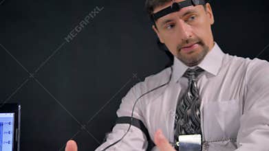 A man takes shaking breaths during a polygraph test.