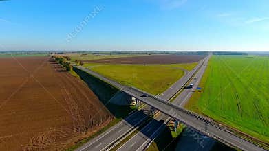 View from above bridge over highway. Cars and truck moving on highway
