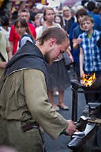 Blacksmith forges item on the anvil.