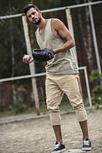 Handsome man throwing baseball ball on court