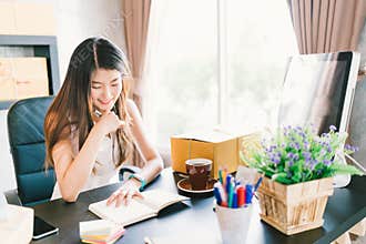 Young and beautiful Asian small business owner work at home office, organizing purchase order. Online marketing packaging delivery
