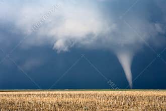 Tornado with dark clouds and stormy sky