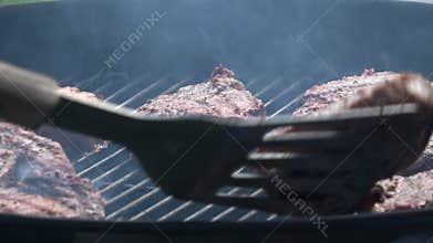 Man`s hands cooking steak on grill