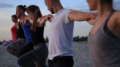Mixed race group of people exercising yoga healthy lifestyle fitness warrior poses