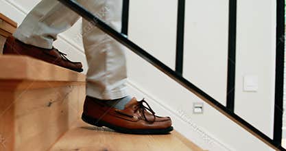 Senior man climbing downstairs with walking stick