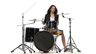 Drummer girl starts playing energetic music, she smiles. White background