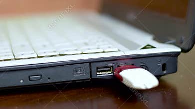 A man connect a USB flash drive to a laptop