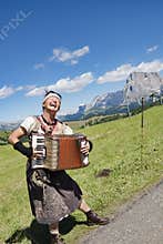 Yodeling in Alps - musician singing and playing accordion