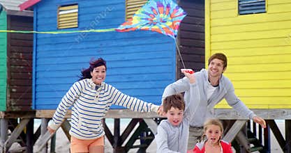 Family flying kite at beach