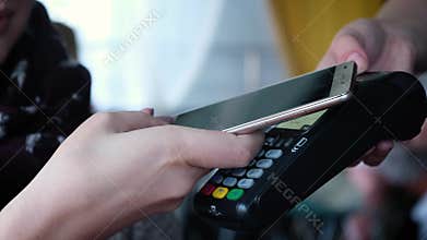 Contactless payment with your smartphone. Paying with a smartphone device on a credit card terminal. Wireless payment