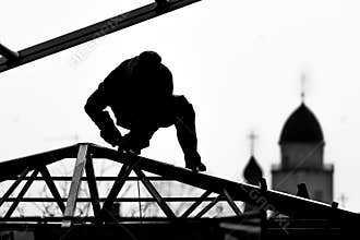 Workers high-builders build a roof