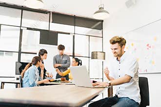 Man celebrate success pose with multi-ethnic diverse team meeting at office. Creative group, business coworker, or college student