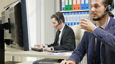 Company workers in suit using headset to talk on the hot line