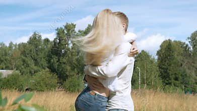 Young beautiful couple running to meet each other. Embrace and whirl.