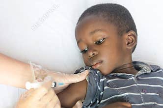 Healthcare and Medical symbol: African black boy gets a vaccination needle