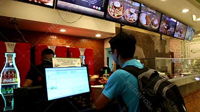 Man orders lunch in a fast food cafe in Bolivia