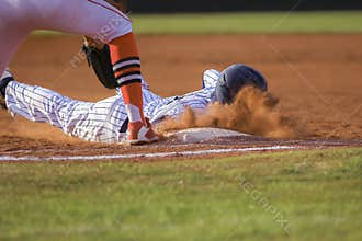 Baseball player sliding first base