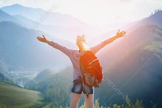 Woman hiking outdoors. Eco Tourism.