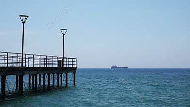 A pier and a distant ship