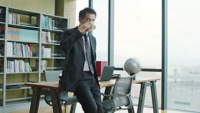 Asian business man relaxing in office