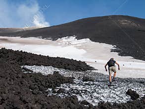 Climbing on the Black Ashy Slopes of Etna Volcano with Remaining Snow