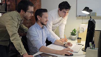 Team group work on computer architecture building project in office