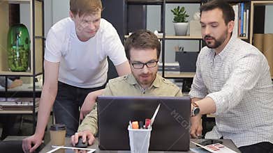 Coworkers men explains work plans sitting behind laptop inside office