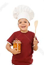 Little boy chef with a jar of canned fruit
