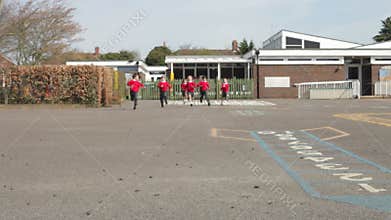 Elementary School Pupils Running Into Playground