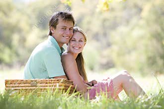 Couple at park having a picnic and smiling