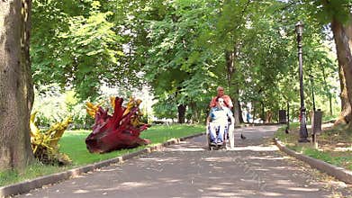 Father walking with his disabled young son