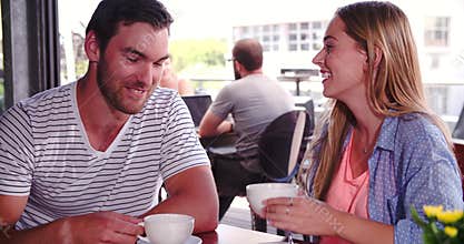 Woman Joins Man Sitting At Table In Coffee Shop