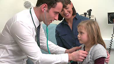 Doctor Listening To Child's Chest In Surgery