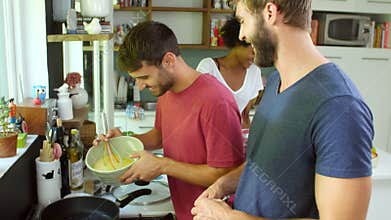 Group Of Friends Cooking Breakfast In Kitchen Together